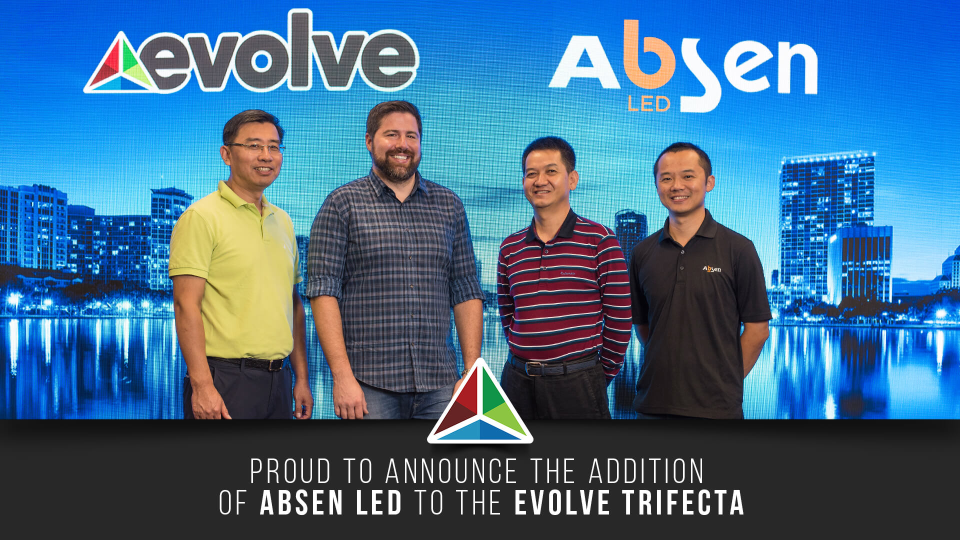 A group of men standing in front of a city.